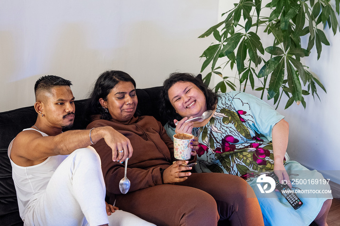 Friends eating ice cream and watching tv