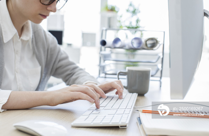 Woman typing on keyboard