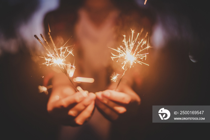 Female hand enjoy with burning Sparkler blast in new year party