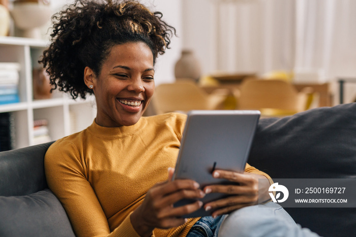 Mixed race woman is having a video call at home