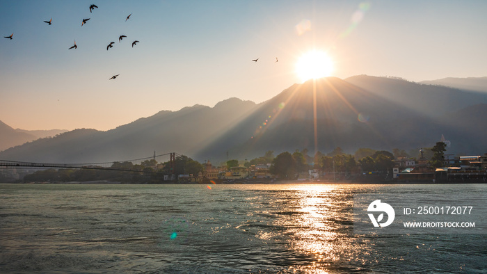 Spectacular panoramic cityscape of Rishikesh during sunrise, the yoga capital of World located in foothills Himalayas along banks of river Ganga or Ganges in Uttarakhand state of India.