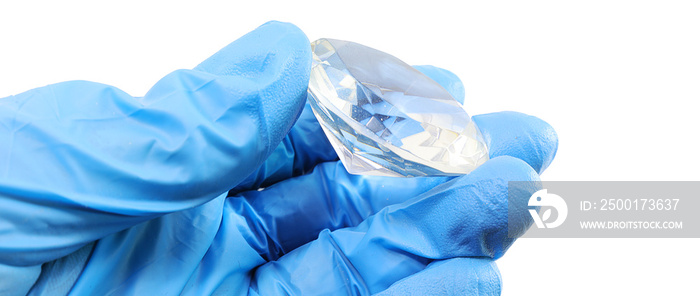 hand with glove and a large precious stone that must be checked