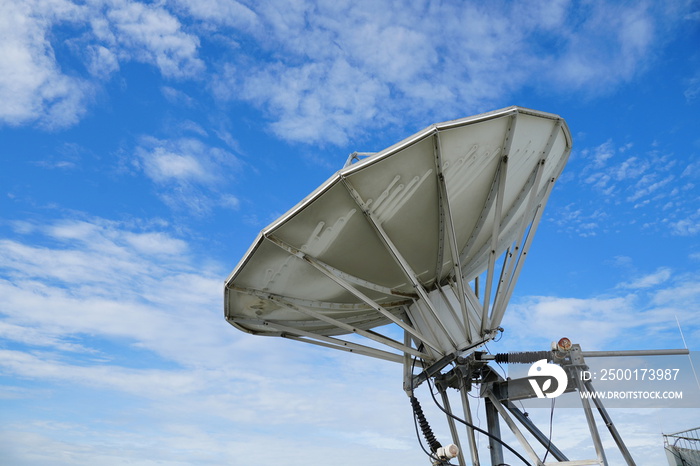 satellite dish antenna radar big size against clouds sky background