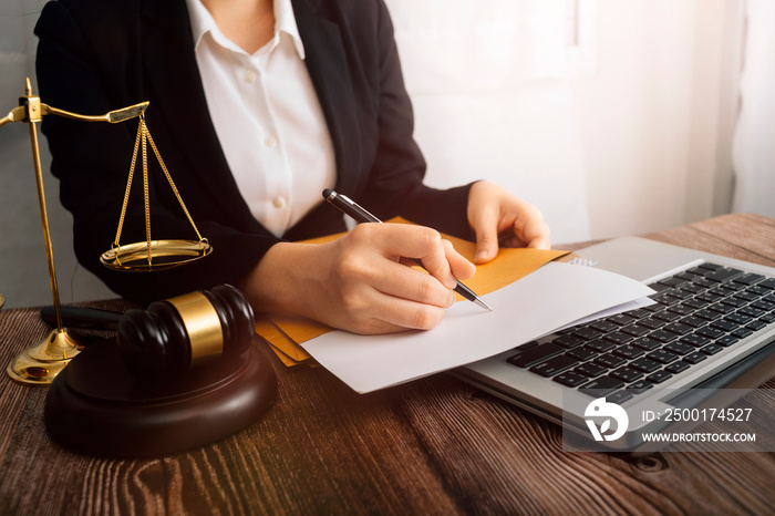 Business and lawyers discussing contract papers with brass scale on desk in office. Law, legal services, advice, justice and law concept