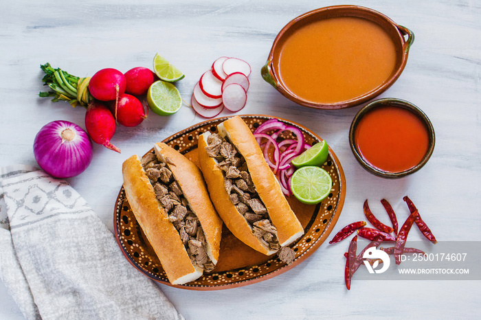 tortas ahogadas, traditional Mexican Food from Jalisco Guadalajara Mexico, spicy sandwich in a red sauce