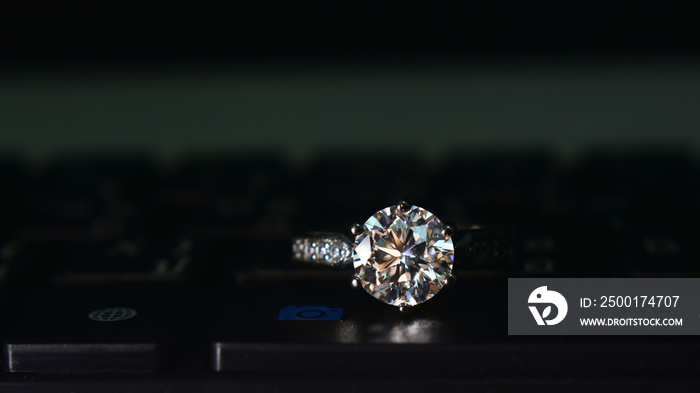 White gold ring with large round diamonds Placed on the keyboard