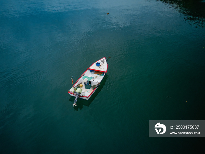 Aerial Drone image of a colorful rowboat just offshore on a Costa Rica Beach