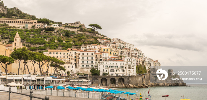 Panoramic view of beautiful Amalfi in grey colours in autums on hills leading down to coast, Campania, Italy. Amalfi coast is most popular travel and holiday destination in Europe.