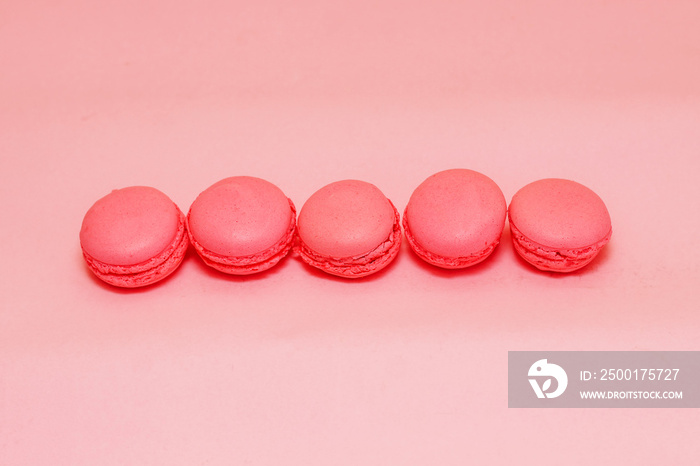 French pink macaroon cookies on silk tablecloth