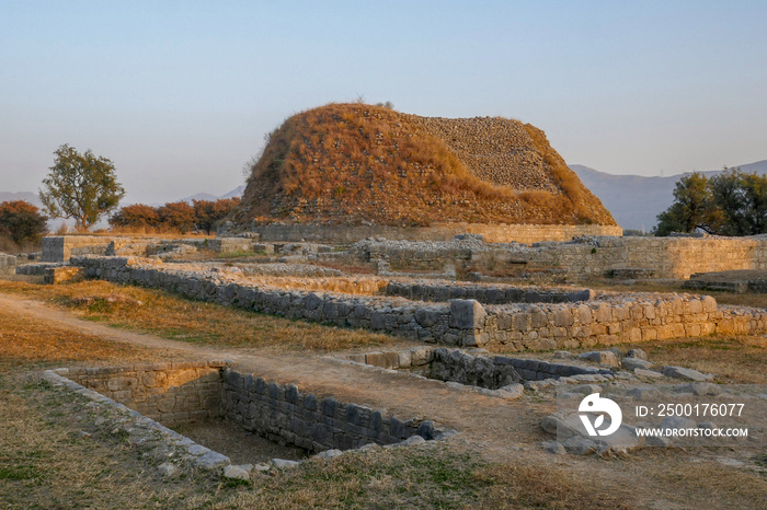 Landscape view at sunset of the buddhist ruins of Dharmarajika, the Great Stupa in ancient Taxila, Punjab, Pakistan, a UNESCO World Heritage site