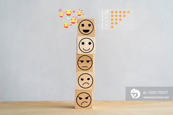 Wooden blocks with icon happy face smile symbol on wood table, evaluation, Increase rating