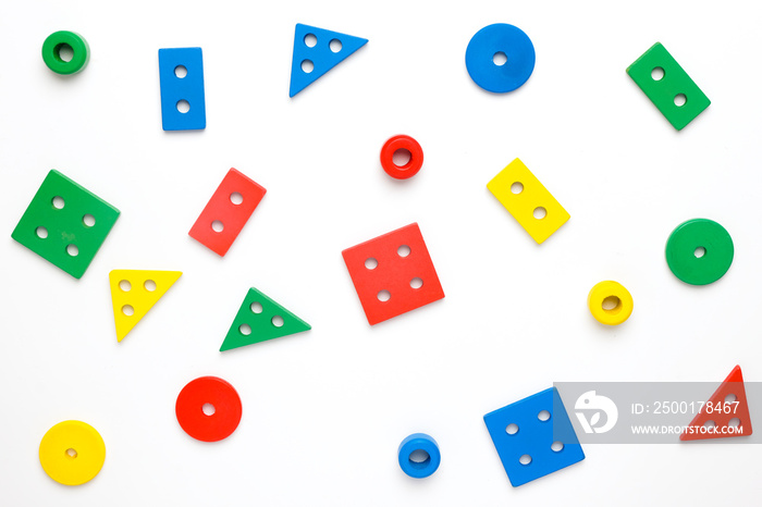 Flatlay of wooden montessori educational toys shape on isolated white background.