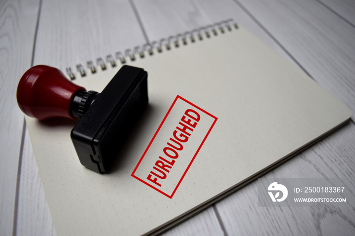 Red Handle Rubber Stamper and Furloughed text isolated on White Background.