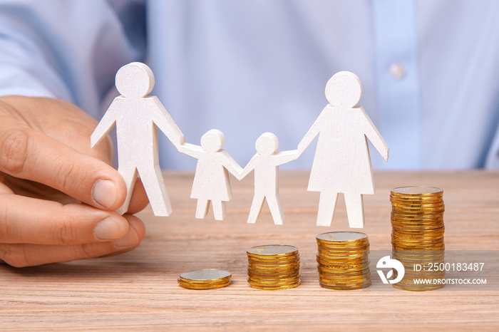 Budget of the family. Coins pile and the symbol of the family