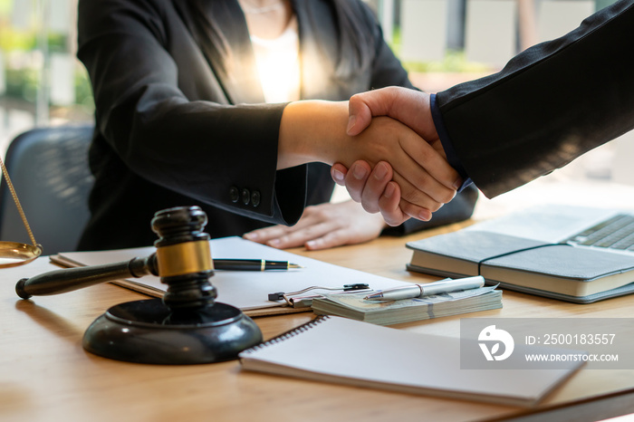 Businessman shaking hands to seal a deal with his partner lawyers or attorneys discussing a contract agreement.Legal law, advice, and justice concept.