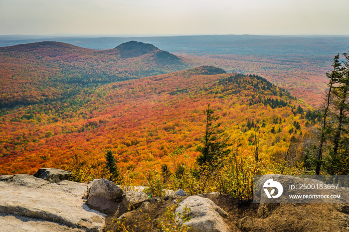 View on the mountains and the fall foliage of Mont Megantic National park from a belvedere along the  Sentier des Cimes  hiking trail, in Eastern Townships, Quebec, Canada