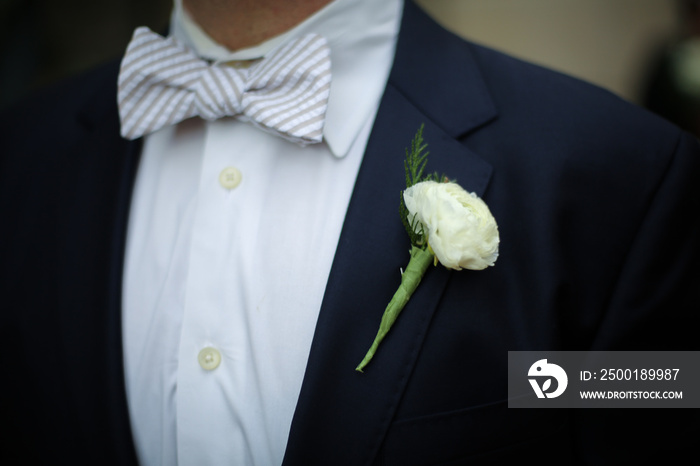 Groom in Blue Suit Jacket, White Carnation boutonniere, with blue seersucker bow tie Wedding Photography