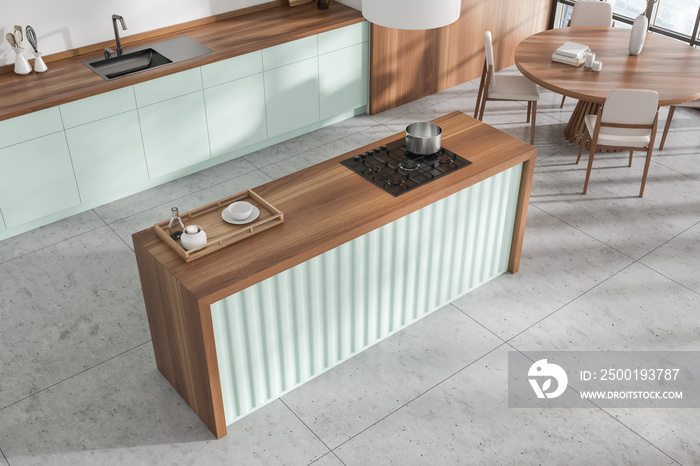 Top view of kitchen interior with countertop and dining area near window