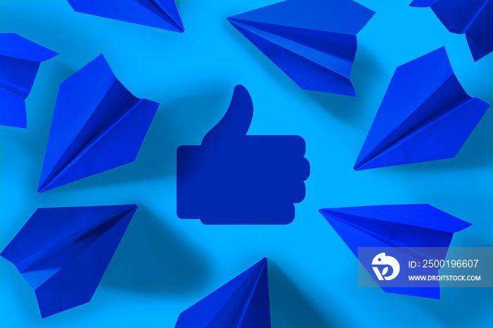 Paper plane and thumbs up like social network icon concept. Design with blue airplane background.