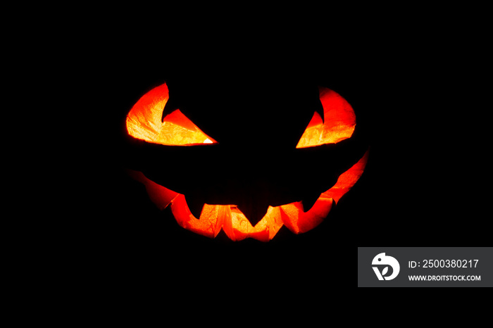 Glowing eyes and mouth of halloween pumpkin (Jack o lantern) on black background. Halloween