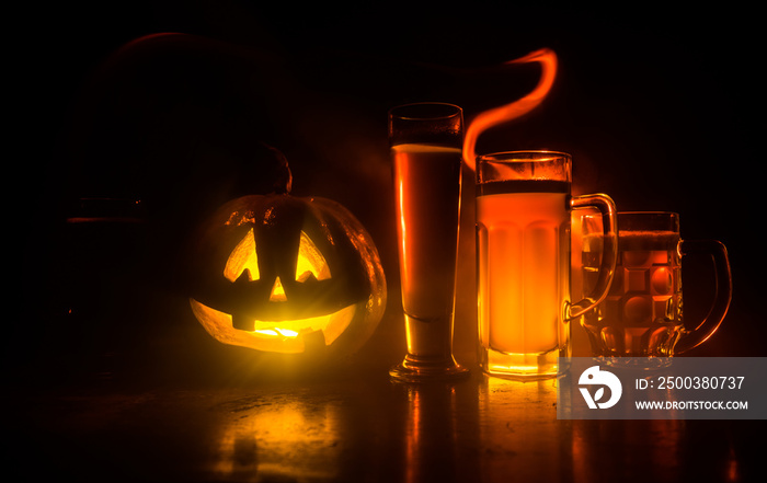 Glass of cold light beer with pumpkin on a wood background for Halloween. Glass of fresh beer and pu