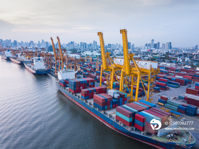 Aerial view of container ship loading containers by working crane in port terminal with container sh