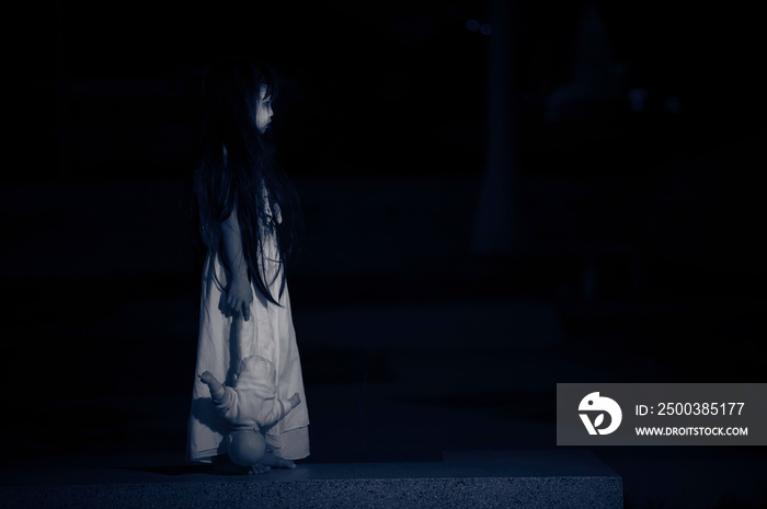 sad child ghost at night,Halloween  Festival concept,Friday 13th,Horror movie scene,A girl with doll