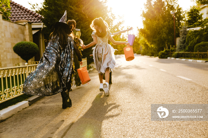 White children walking down street during trick-or-treating