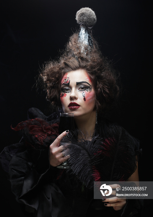 Young woman with gothic make-up and crazy hair-style. Creative fashion masquerade.