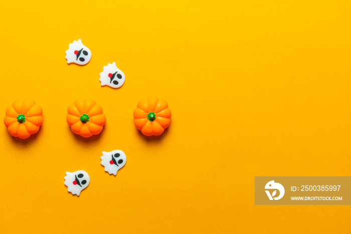Halloween holiday concept, Spooky pumpkins and ghosts in orange background with copy space for text,