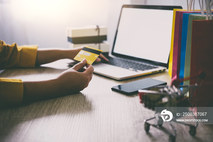 Young woman typing laptop for online shopping website and holding card pay by credit card, Online pa