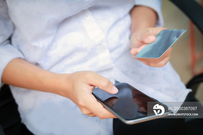 soft focus woman asian using phone and credit card shopping onli