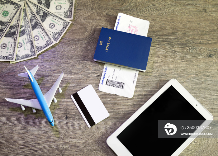 Preparation for Traveling concept, airplane, laptop, boarding pass, passport, credit card, on vintag