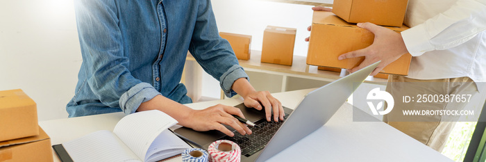 Startup small business entrepreneur SME, young asian man working with laptop computer and delivery p