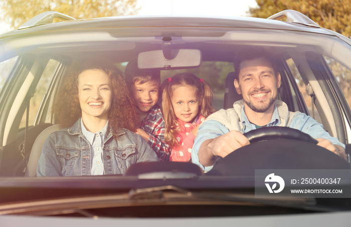 Young family with children in car