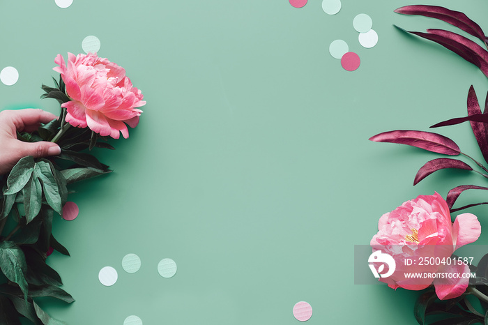 Greeting card design with pink peony flowers on faded green background, text space. Trendy casual na