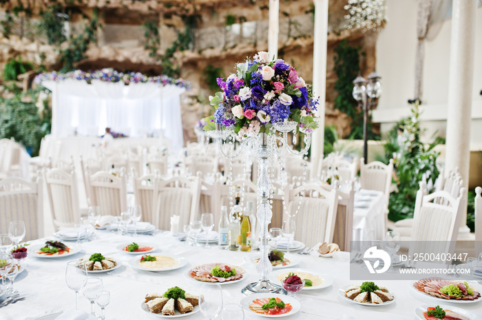 Violet and purple flowers at awesome wedding table.