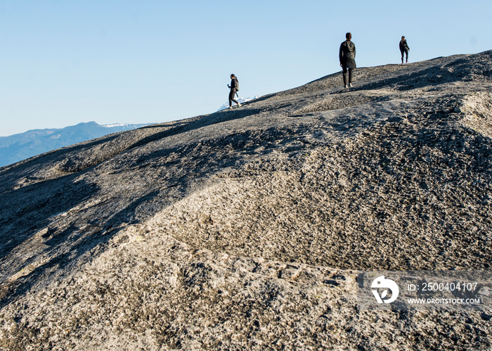 Three young female hikers on rock, Squamish, British Columbia, Canada