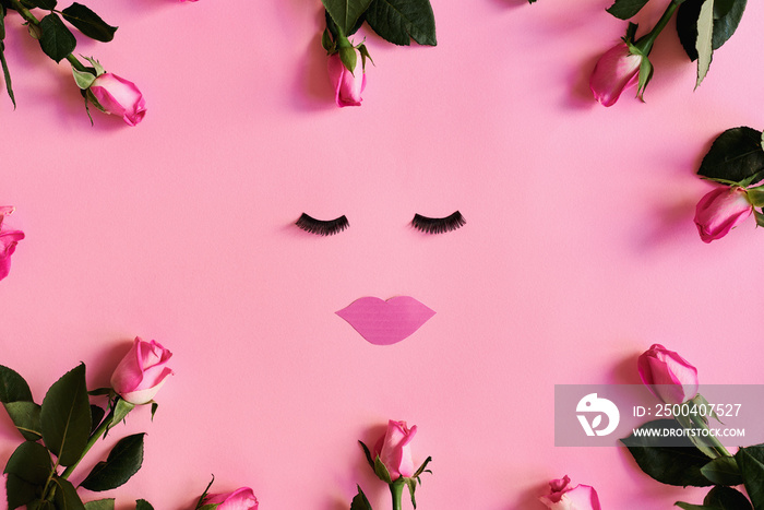Feminine flat lay with rose flowers on pink background. False eyelashes and paper lips. Beauty care 