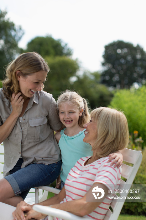 Happy multi-generation women bonding in garden