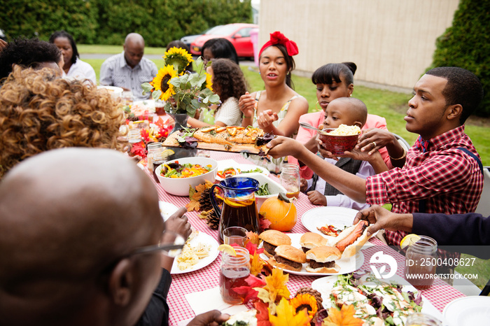 Multigenerational family having dinner at table outdoors