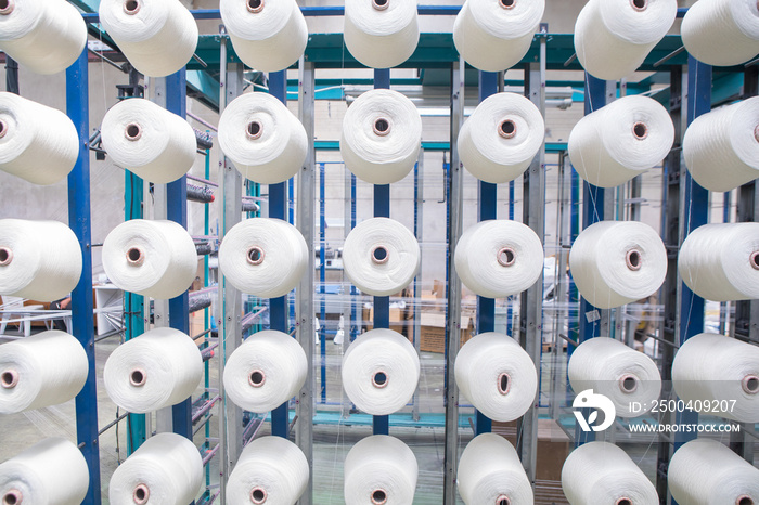 Group of bobbin thread cones on a warping machine in a textile mill. Yarn ball making in a textile f