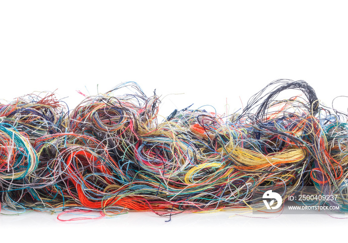 Colorful tangled threads isolated on white background. Closeup.