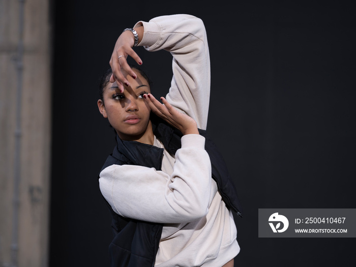 Teenage girl in sports clothing gesturing in city