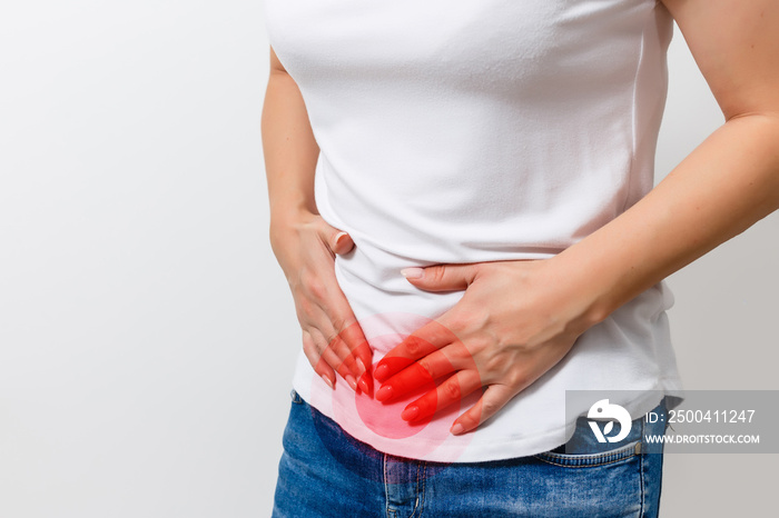 Abdominal pain of a young woman. Taken from the front view on a white background. Abdominal pain Men