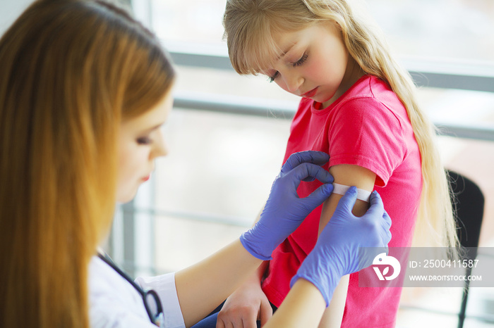 Doctor injecting vaccination in arm little child girl,healthy and medical concept