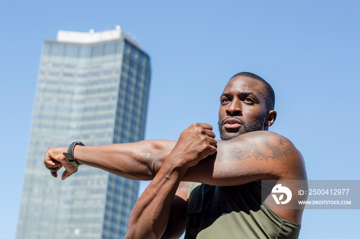 Mid adult man stretching in urban setting