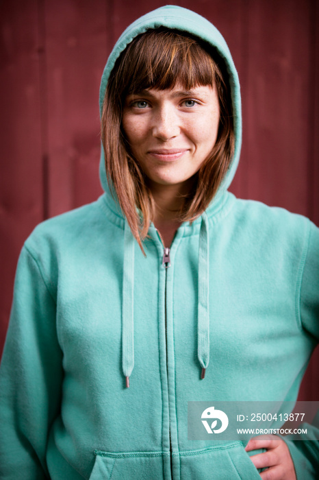Portrait of young woman in green hood