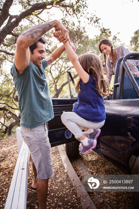 Family with one child (4-5) getting out of car