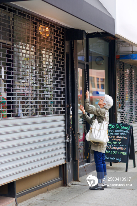 Senior woman opening her cafe